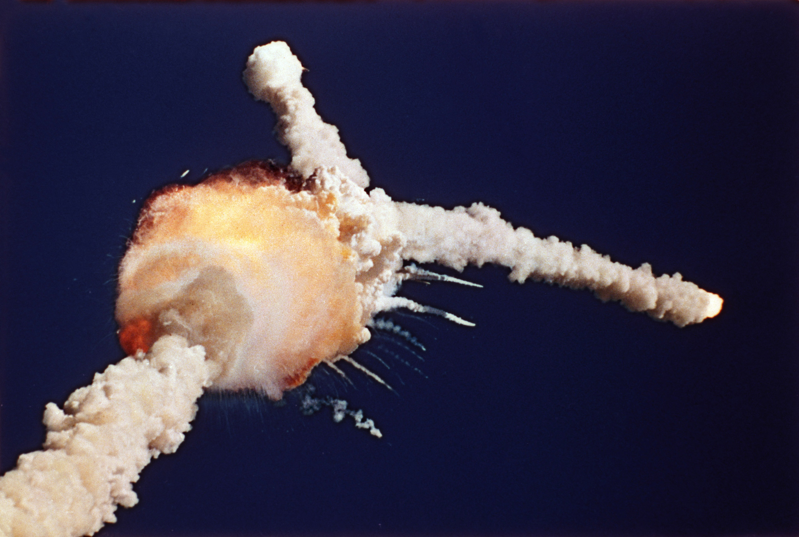 The Space Shuttle Challenger explodes shortly after lifting off from Kennedy Space Center, Fla., Tuesday, Jan. 28, 1986. All seven crew members died in the explosion, which was blamed on faulty o-rings in the shuttle's booster rockets. The Challenger's crew was honored with burials at Arlington National Cemetery. (AP Photo/Bruce Weaver)